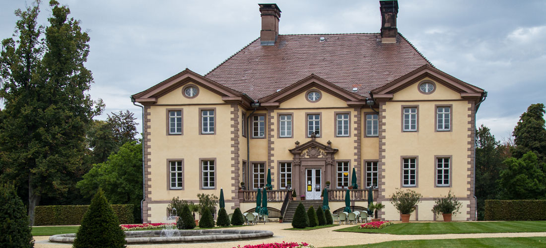 Kartanon juhlava puutarha toivottaa vieraat tervetulleeksi.